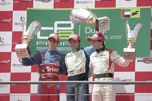 2008 GP2 Asia Series. Saturday Race. Dubai. Dubai Autodrome. 12th April. Marco Bonanomi (ITA, Piquet Sports) celebrates victory on the podium with Sebastien Buemi (SUI, Trust Team Arden) and Jerome D'Ambrosio (BEL, Dams)