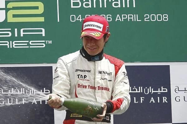 2008 GP2 Asia Series. Sunday Race. Bahrain International Circuit. Sakhir, Bahrain. 6th April. Kamui Kobayashi (JPN, Dams) celebrates his victory on the podium. World Copyright: Andrew Ferraro / GP2 Series Media Service. Service ref:__H0Y3355.jpg