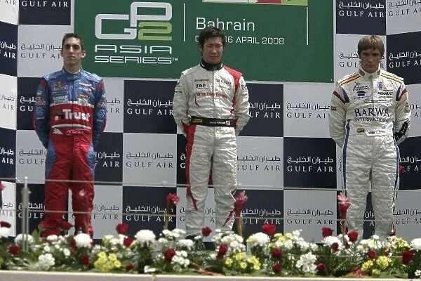 2008 GP2 Asia Series. Sunday Race. Bahrain International Circuit. Sakhir, Bahrain. 6th April. Kamui Kobayashi (JPN, Dams) celebrates victory on the podium with Sebastien Buemi (SUI, Trust Team Arden) and Vitaly Petrov (RUS)