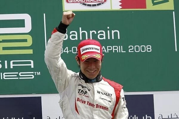 2008 GP2 Asia Series. Sunday Race. Bahrain International Circuit. Sakhir, Bahrain. 6th April. Kamui Kobayashi (JPN, Dams) celebrates victory on the podium. World Copyright: Andrew Ferraro / GP2 Series Media Service. Service ref:__H0Y3297.jpg