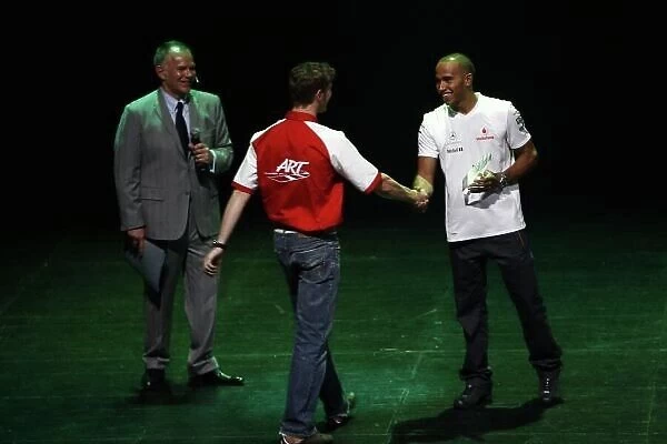 2008 GP2 Series Launch Party. Barcelona, Spain. 24th April 2008. Lewis Hamilton, (McLaren Mercedes) presents Romain Grosjean (FRA, ART Grand Prix) with the 2008 GP2 Asia trophy