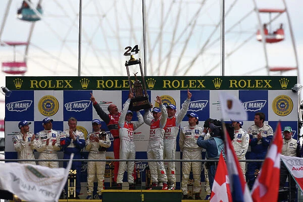 2008 Le Mans 24 Hours: Rinaldo Capello / Allan McNish / Tom Kristensen, no 2 Audi R10 TDI, lift the trophy on the podium. Portrait. Podium