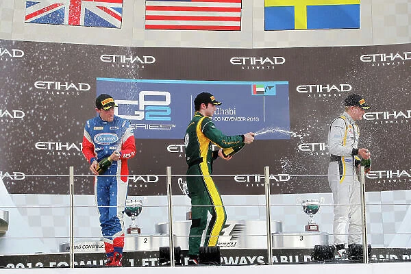 2013 GP2 Championship. Round 11. Yas Marina Circuit, Abu Dhabi, United Arab Emirates. 2nd November 2013. Saturday Race. Alexander Rossi (USA, Caterham Racing) celebrates his victory on the podium with Jolyon Palmer (GBR)
