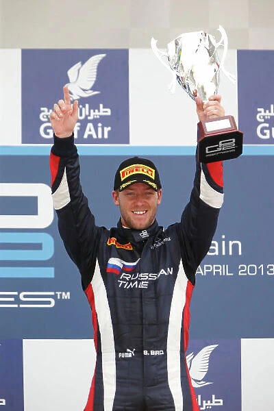 2013 GP2 Series. Round 2. Bahrain International Circuit, Sakhir, Bahrain. 21st April. Sunday Race. Sam Bird (GBR, RUSSIAN TIME) celebrates his victory on the podium. World Copyright: Glenn Dunbar / GP2 Series Media Service. Ref: _89P4342