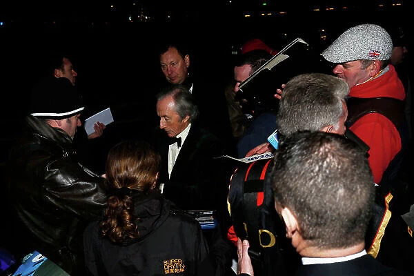 2014 Autosport Awards. Grosvenor House Hotel, Park Lane, London. Sunday 7 December 2014. Sir Jackie Stewart signs autographs outside the Grosvenor House Hotel. World Copyright: Zak Mauger / LAT Photographic. ref: Digital Image _L0U9248