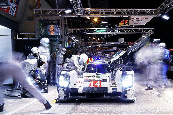 2014 Le Mans 24 Hours. Circuit de la Sarthe, Le Mans, France. Sunday 15 June 2014. Romain Dumas / Neel Jani / Marc Lieb, Porsche, makes a night pit stop World Copyright: Adam Warner / LAT Photographic. ref: Digital Image _L5R2909
