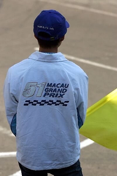51st Macau Grand Prix: A marshal waves a yellow flag