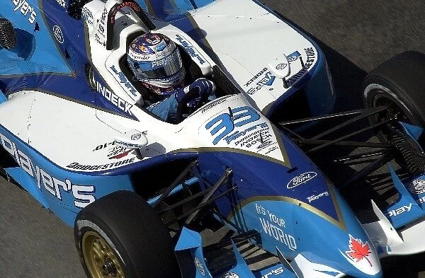Alex Tagliani, (CDN), Ford-Cosworth  /  Reynard, wheels through turn three during practice for the Molson Indy Vancouver. Concord Pacific Place, Vancouver, B. C. Can. 28 July, 2002