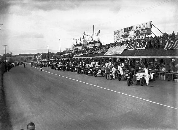 Ards, Northern Ireland, Great Britain. 7 September 1935: The cars line up in front of the pits with WT McCalla and Freddie Dixon  /  Walter Handley to the fore