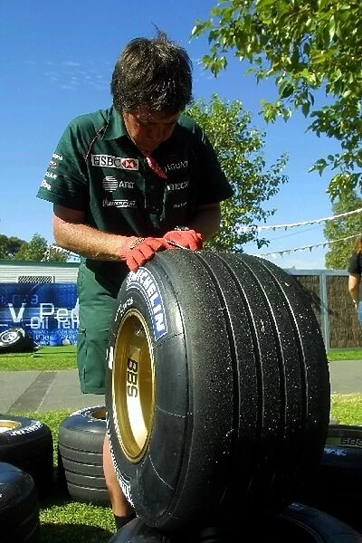 Australian GP: A Jaguar mechanic checks the Michelin tyres
