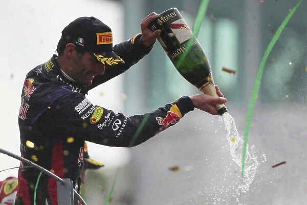 Autodromo Nazionale di Monza, Monza, Italy. 8th September 2013. Mark Webber, Red Bull Racing, 3rd position, pours Champagne from the podium. World Copyright: Andy Hone / LAT Photographic. ref: Digital Image HONY8401
