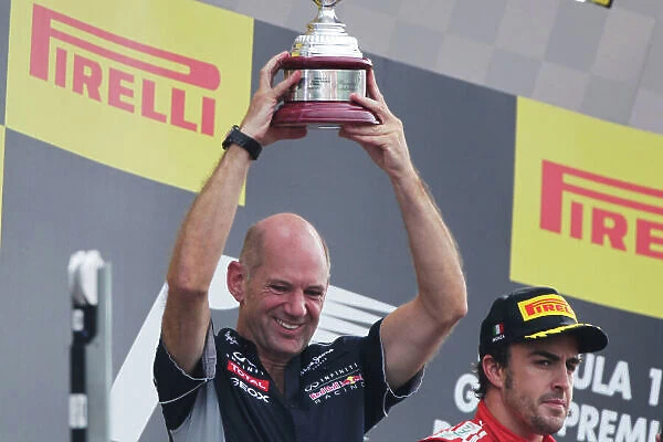 Autodromo Nazionale di Monza, Monza, Italy. 8th September 2013. Adrian Newey, Chief Technical Officer, Red Bull Racing, lifts the constructors trophy. World Copyright: Andy Hone / LAT Photographic. ref: Digital Image HONY8315