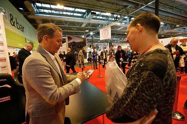 Autosport International Show NEC, Birmingham. Sunday 12 January 2014. Martin Brundle signs an autograph for a fan. World Copyright:Alastair Staley / LAT Photographic ref: Digital Image _R6T5796