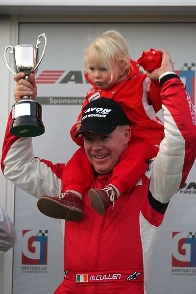 British GT Championship: Race winner Michael Cullin celebrates with the trophy on the podium