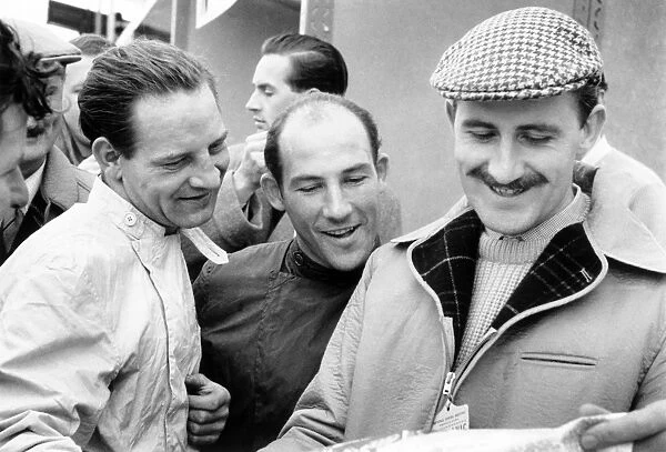 Brussels, Belgium. 8 April 1960: Left-to-right: Innes Ireland, Stirling Moss and Graham Hill. Portrait