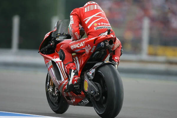 Casey Stoner Ducati Marlboro Team gets his bike fired up again after a push from