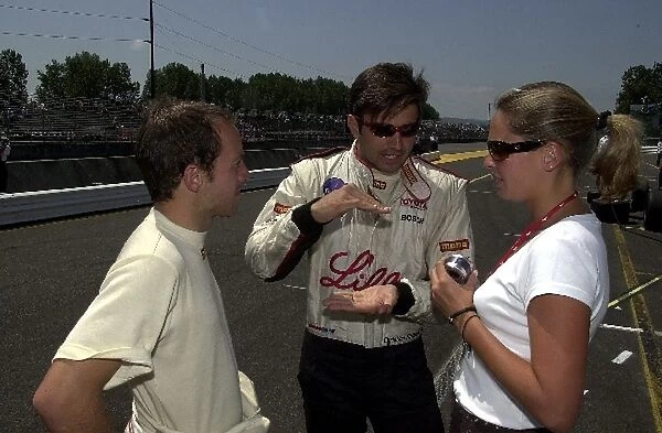 Christian Fittipaldi explains the fine art of going fast before qualifying for the G. I. Joes 200. Portland International Raceway, Portland, Or. 16 June, 2002