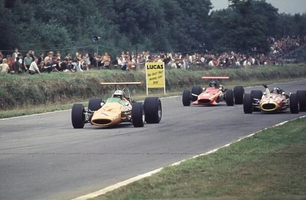 Denny Hulme and Jacky Ickx pass Silvio Moser British Grand Prix, Brands Hatch