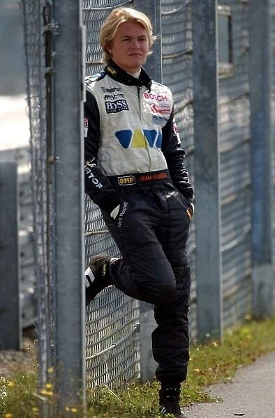 A dissapointed Nico Rosberg (FIN), Team Rosberg, Dallara-Opel, waits behind the fences for the race to end. F3 Euro Series, Rd 11&12, Nrburgring, Germany. 16 August 2003. DIGITAL IMAGE
