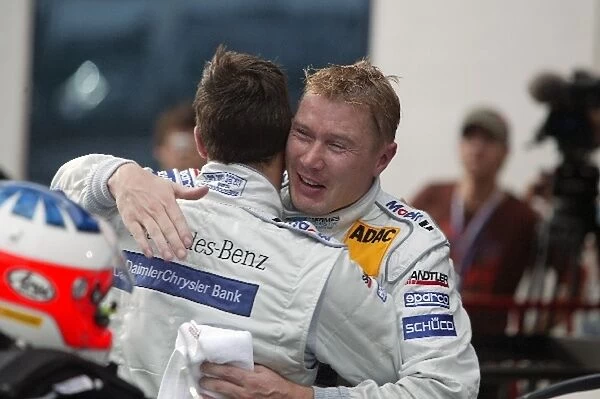 DTM: Mika Hakkinen congratulates AMG Mercedes team mate Gary Paffett who won the race