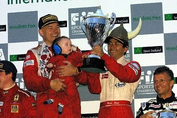 FIA Sports Car Championship: Race winner John Nielsen with his baby and team mate Hiroki Katoh