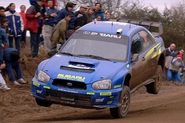 FIA World Rally Championship: Chris Atkinson, Subaru Impreza WRC, lands on one wheel on stage 13