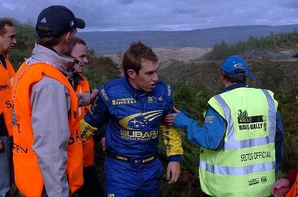 FIA World Rally Championship: Chris Atkinson, Subaru, helped by marshalls after a big off on Stage 7