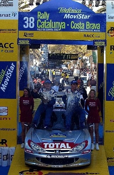 FIA World Rally Championship: Gilles Panizzi, right, and co-driver and brother Herve Panizzi, left, Peugeot 206 WRC spray the victory champagne