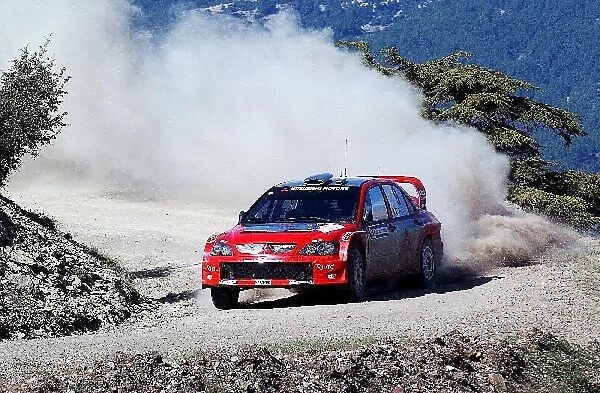 FIA World Rally Championship: Gilles Panizzi with co-driver Herve Panizzi Mitsubishi Lancer WRC04 on stage 8. He is running under the SUPERally system