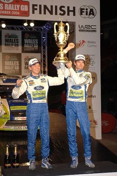 FIA World Rally Championship: L-R: Timo Rautiainen and R-Marcus Gronholm with the winners trophy on the podium in the Millennium Stadium