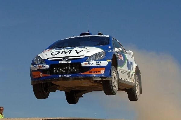 FIA World Rally Championship: Manfred Stohl, Peugeot 307 WRC, flies at the jump on Stage 11