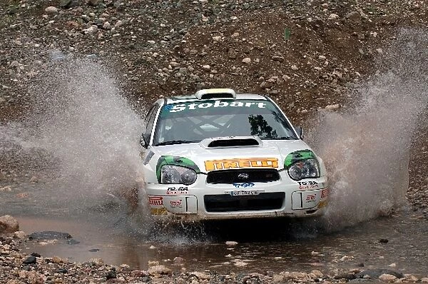 FIA World Rally Championship: Mark Higgins, Subaru Impreza WRC, at the watersplash on Stage 13