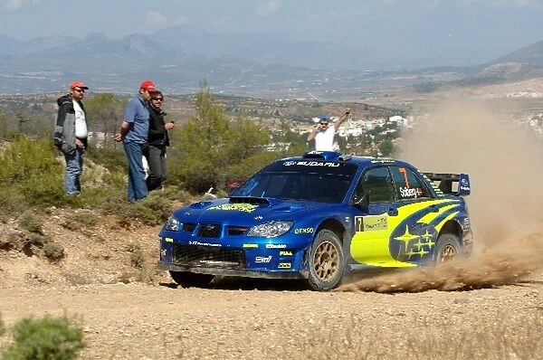 FIA World Rally Championship: Petter Solberg, Subaru Impreza WRC, on Stage 3, with the town of Thiva in the background
