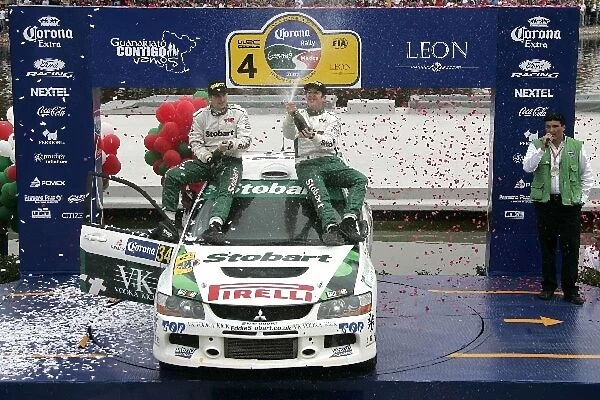 FIA World Rally Championship: PWRC winners R-Mark Higgins and L-Scott Martin, Ford Focus, spray their champagne on the podium