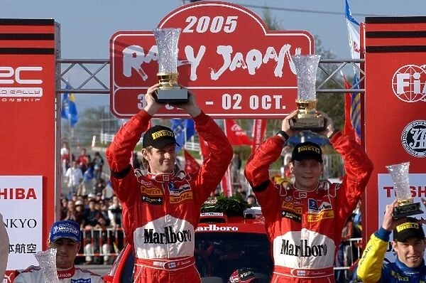 FIA World Rally Championship: Rally Japan winners Marcus Gronholm and Timo Rautiainen, Peugeot, with the winners trophies