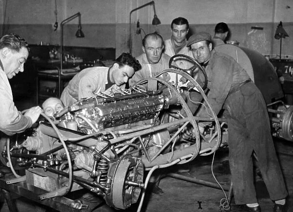 Formula 1 World Championship. Mechanics work on a Maserati engine inside a 250F chassis. World Copyright - LAT Photographic