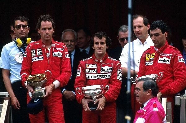 Formula 1 World Championship: Winner Alain Prost McLaren MP4  /  4, with 2nd placed Gerhard Berger Ferrari F187 and 3rd placed Michele Alboreto Ferrari