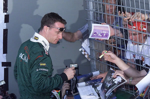 Formula One Australian Grand Prix Albert Park, Melbourne, 9 / 3 / 2000 Eddie Irvine signs autographs for the fans. Portrait ref:18mb digital Pic Steve Etherington / EPI