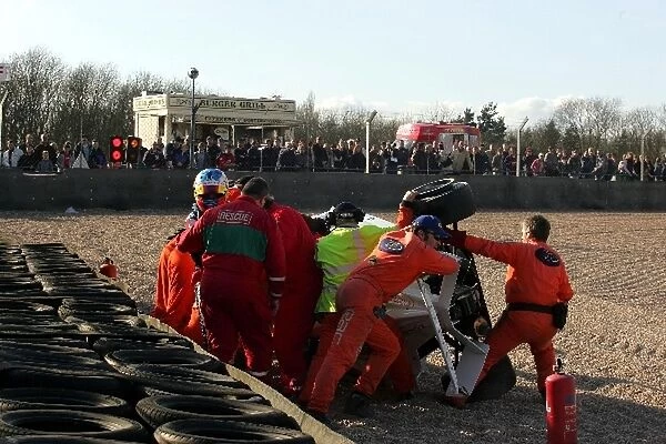 Formula BMW UK Championship: Joe Osborne is helped out of his car after rolling over during a crash