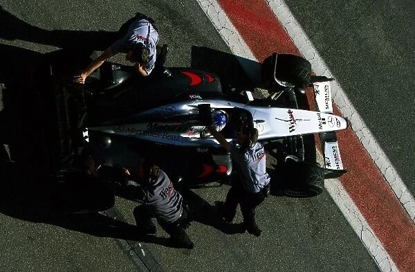 Formula One Testing: Alex Wurz McLaren Mercedes MP4 / 17 is pushed back into the garage by his engineers