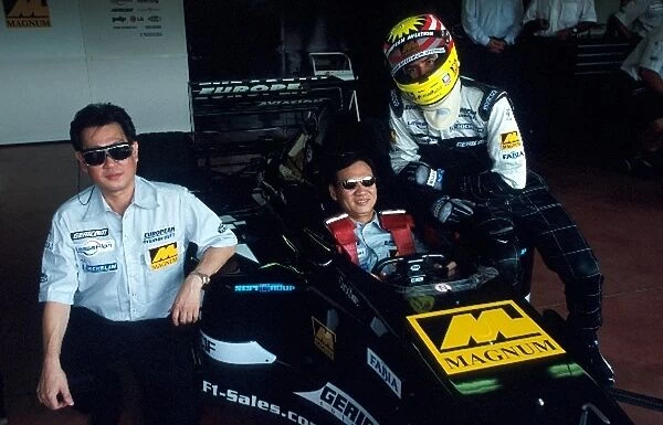 Formula One Testing: Alex Yoong shows representatives of sponsor Magnum around the Minardi PS01