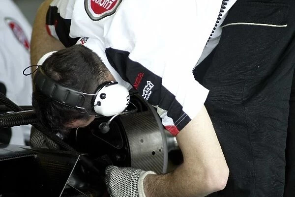 Formula One Testing: A BAR Honda mechanic works on the car of Anthony Davidson