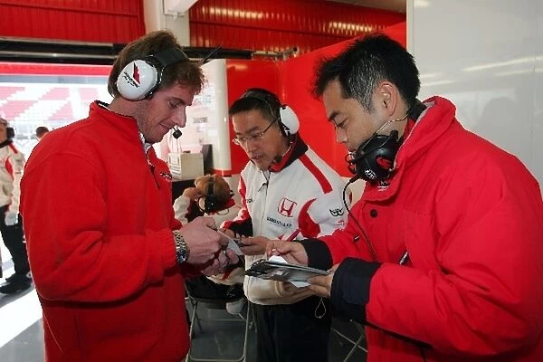 Formula One Testing: Bridgestone engineers with Super Aguri F1 Team engineers in the garage