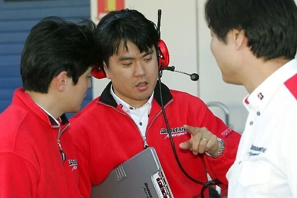 Formula One Testing: Bridgestone technicians chat in the pitlane