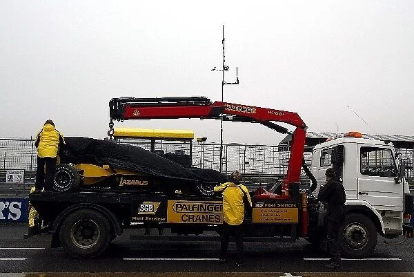 Formula One Testing: The car of Giorgio Pantano Jordan Ford EJ14 returns to the pits on the back of a truck after Pantano had a spin