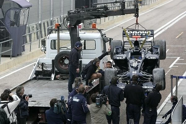Formula One Testing: The car of Nico Hulkenberg Williams FW30 is brought back to the pits after he went into the gravel