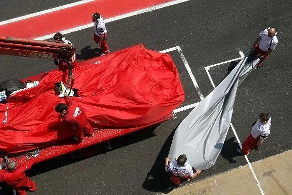Formula One Testing: The car of Timo Glock Toyota TF108 is returned to the pits on a truck after a problem on track