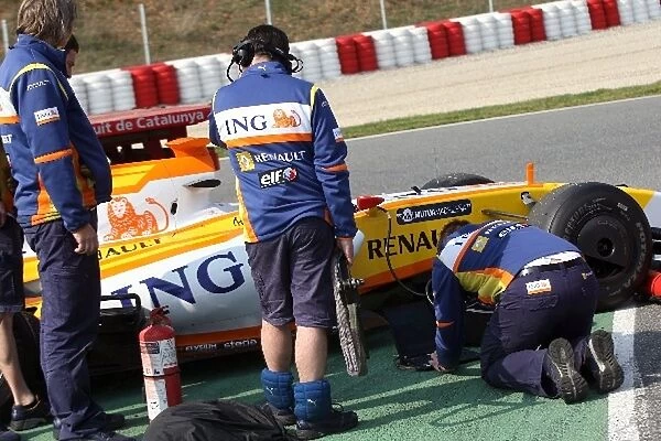 Formula One Testing: Engineers work on the car of Fernando Alonso Renault R29 after it stopped on circuit with a mechanical problem