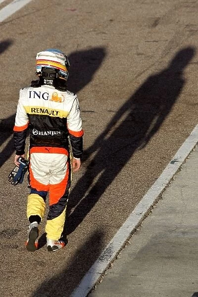Formula One Testing: Fernando Alonso Renault walks down the pitlane after stopping on track