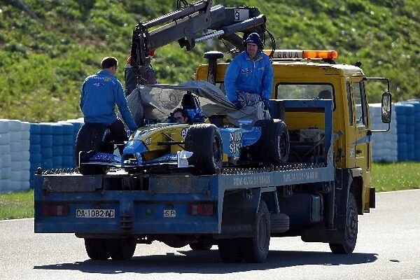 Formula One Testing: Fernando Alonsos Renault R202 gets brought back to the pits following the engine failure he suffered